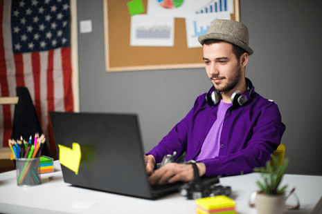 Image of a person in a campaign volunteer office working on a laptop