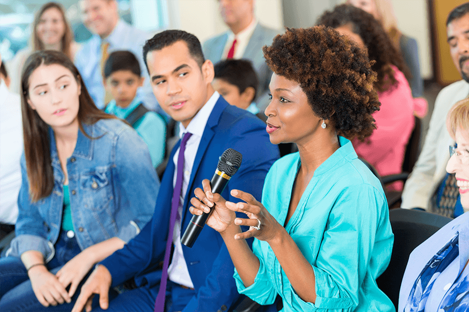 Woman with microphone at a political townhall