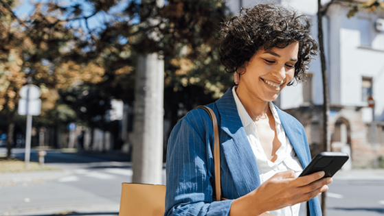 Person happily receives text message while out and about